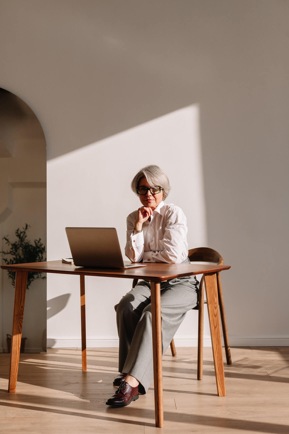 An investor working at a desk with a laptop
